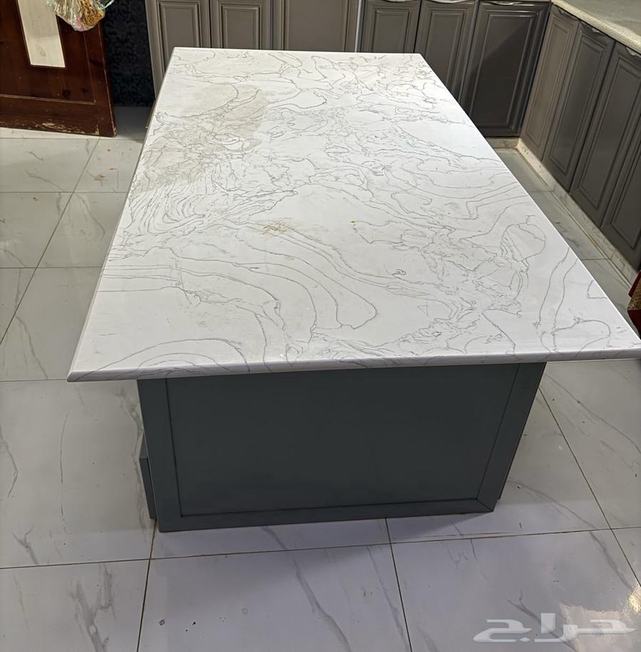 A kitchen island with a side of shelves and four drawers, and on the other side three cabinets.63204510741761111