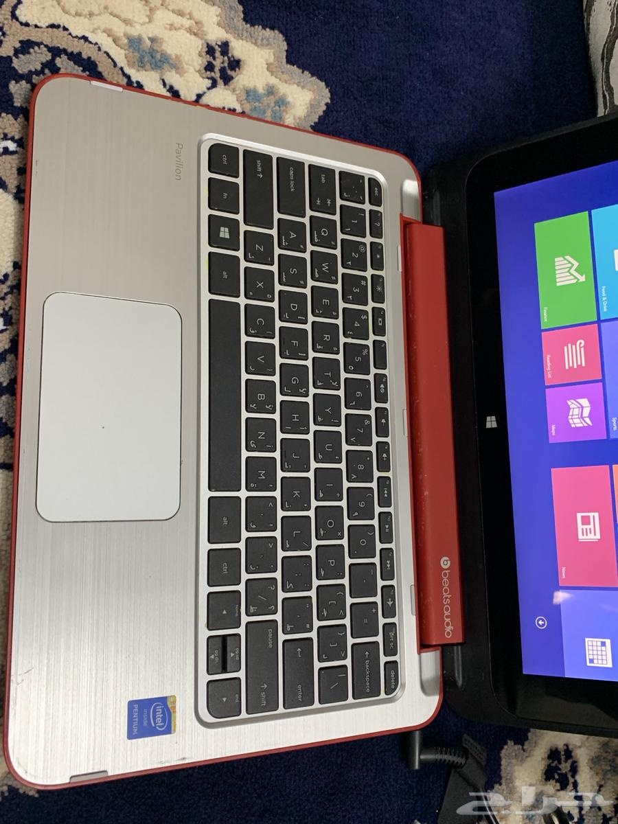 A working laptop computer with a massage device bag.63205077470083111
