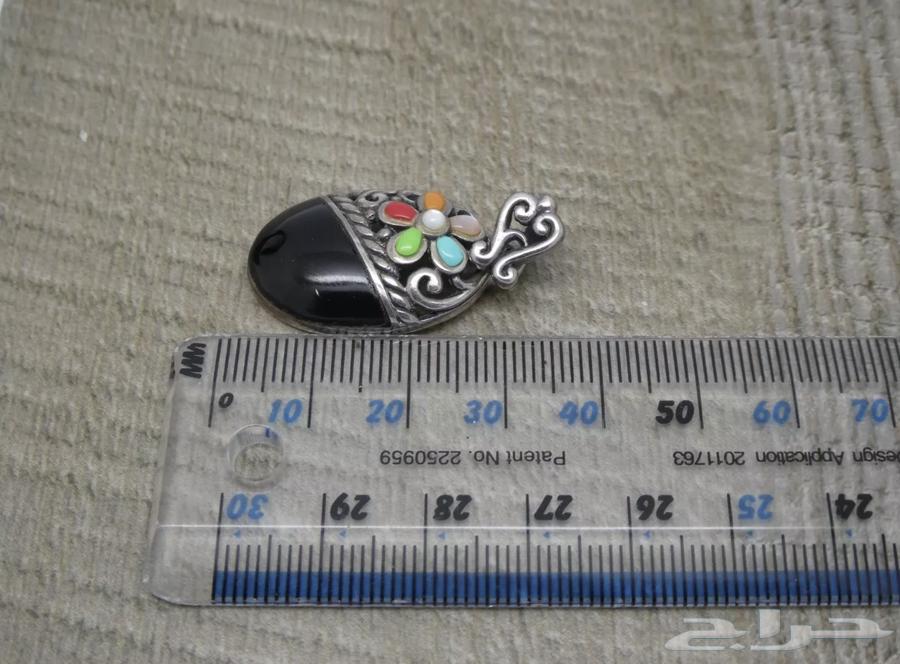 A silver earring with a hallmark, set with various stones63176394262145113