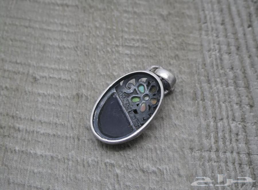 A silver earring with a hallmark, set with various stones63176394262145112