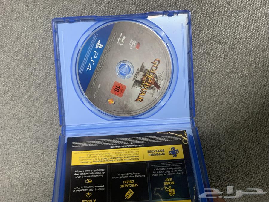 Sony 5 regular user with mouse, keyboard, and God of War 3 game disc.63173251889921114