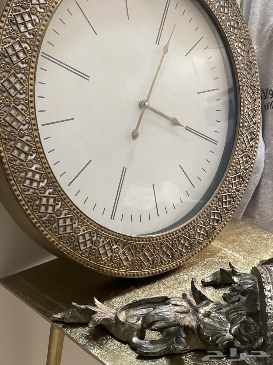 Two wooden shelves, a luxurious iron table, and a large clock63488936810625111