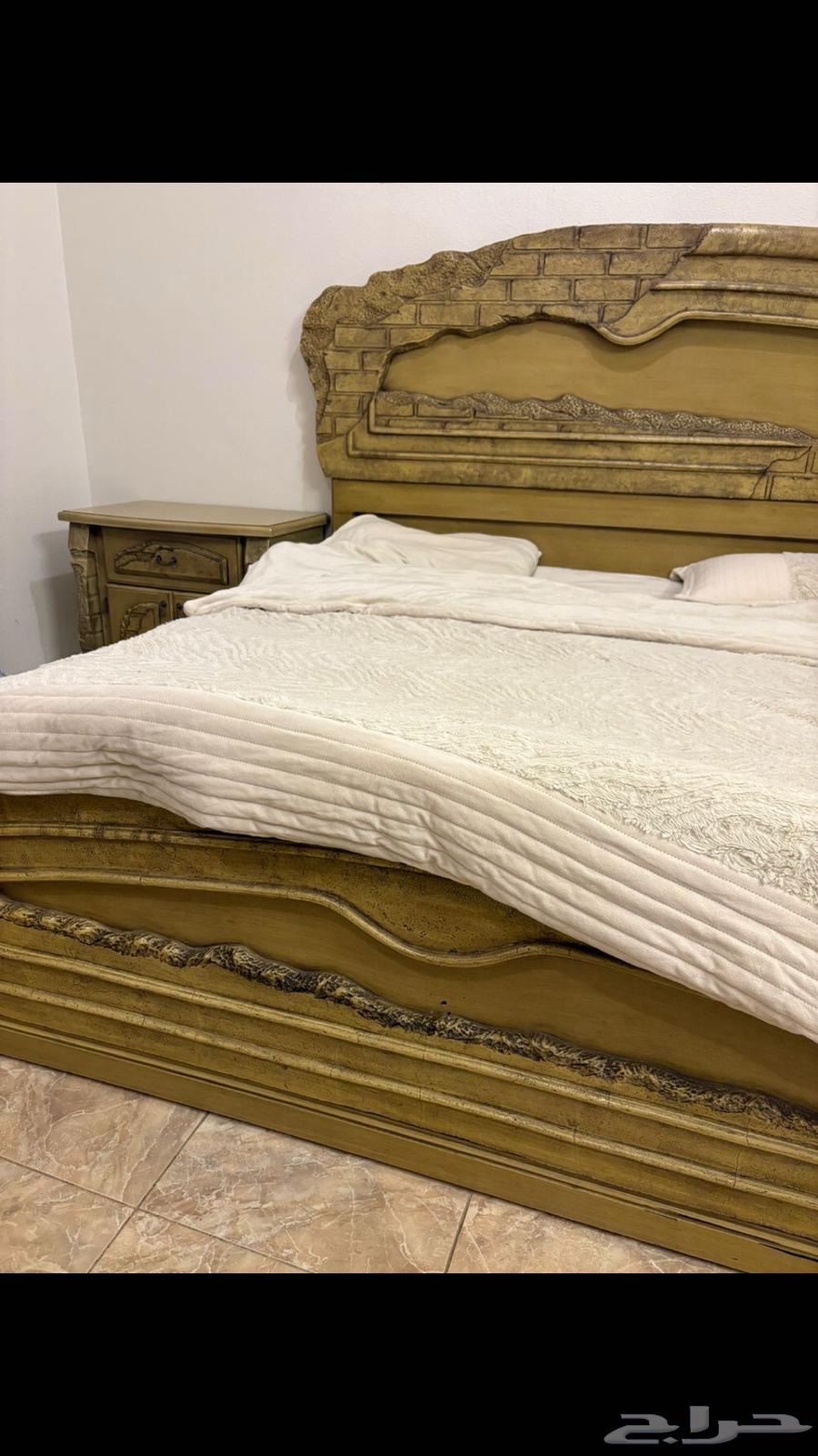 A wooden room with a large bed, wardrobe, and large dressing table and two nightstands63085591397378110
