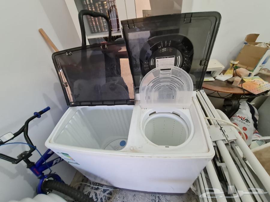 Two washers and a clean dryer, and a clean living room63419677573121113