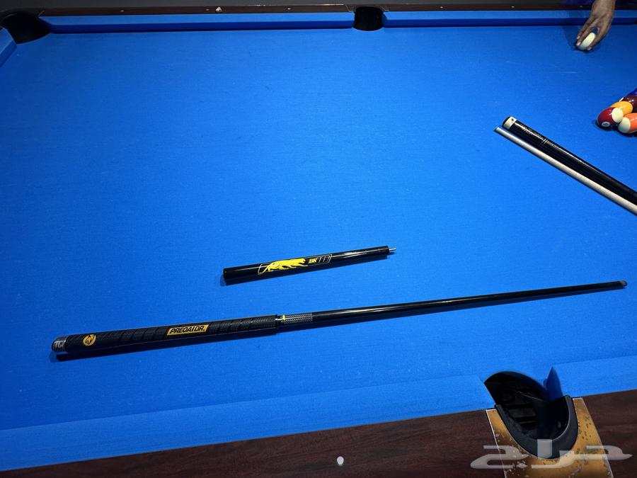 A broken pool cue and a companion.63406778340225112