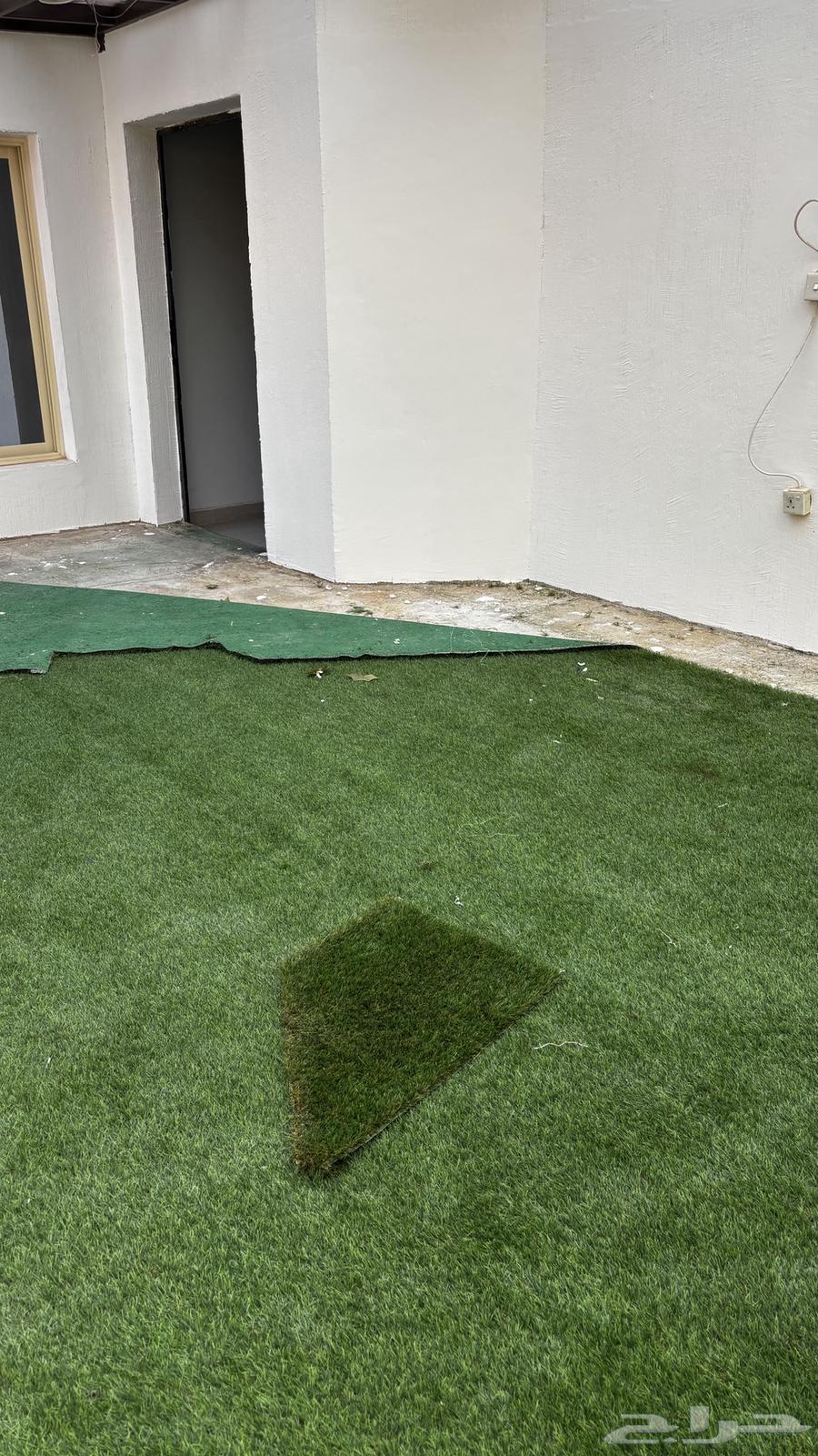 Artificial grass carpet, floor seating, and an iron door630310247415051114