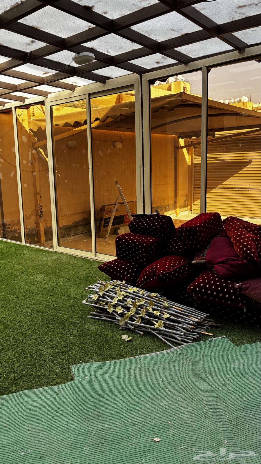 Artificial grass carpet, floor seating, and an iron door63031024741505111