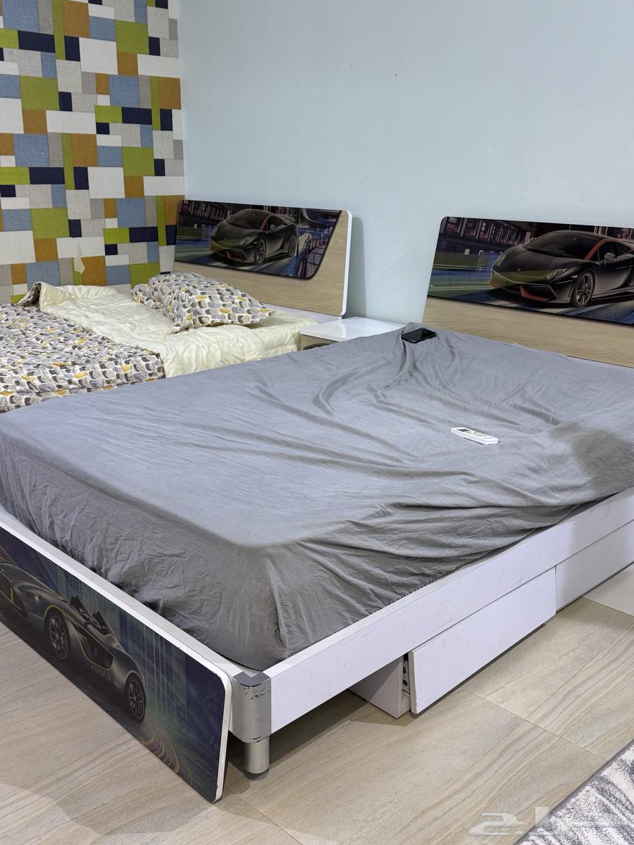 Children's bedroom with two clean beds, two closets, a desk, and mirrors63700740793218112