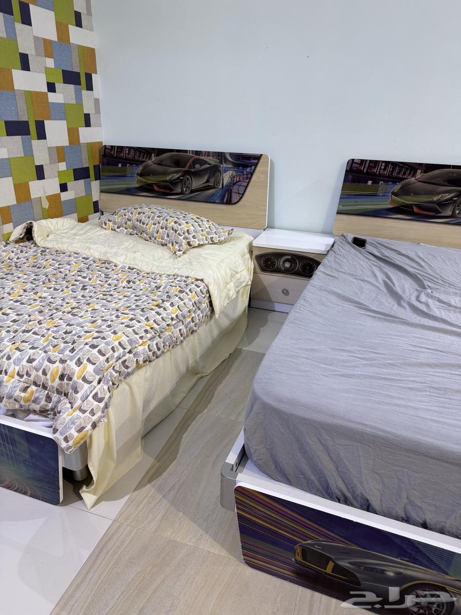 Children's bedroom with two clean beds, two closets, a desk, and mirrors63700740793218113
