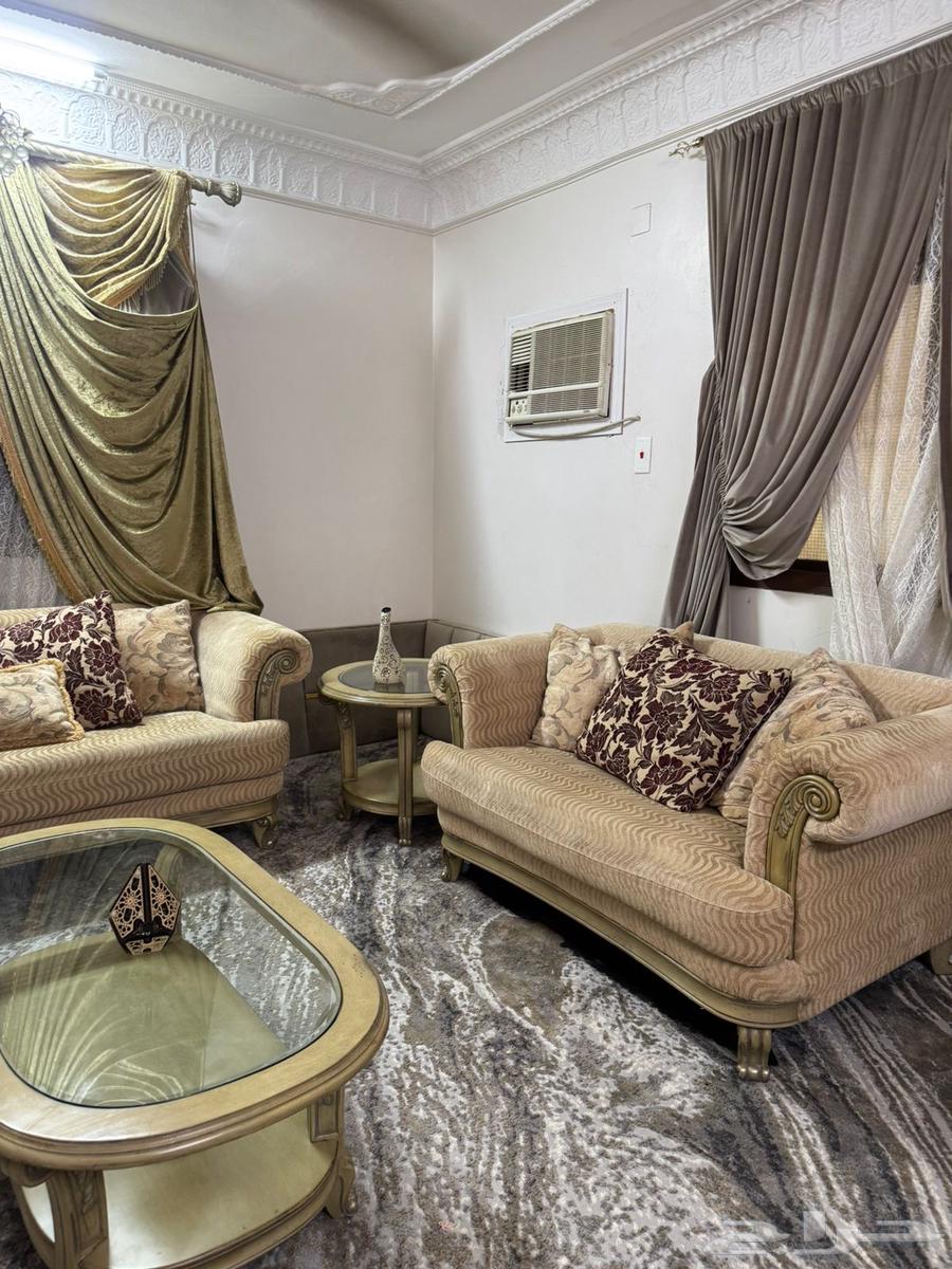 Beige sofa with tables and curtain63655709503490110