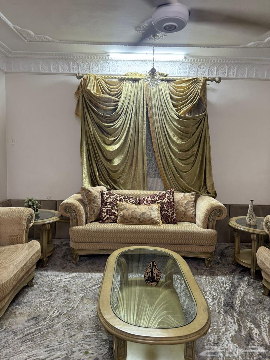Beige sofa with tables and curtain63655709503490111