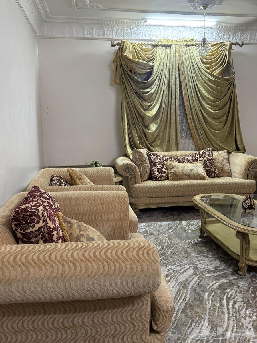 Beige sofa with tables and curtain63655709503490113
