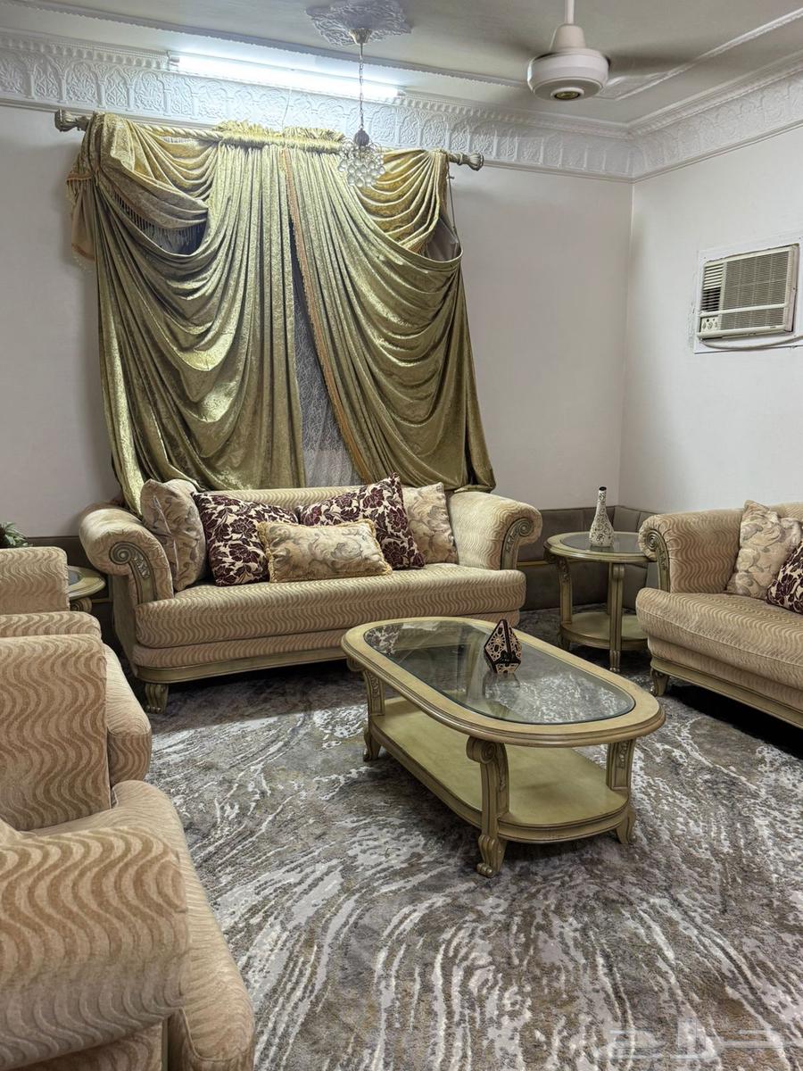 Beige sofa with tables and curtain63655709503490114