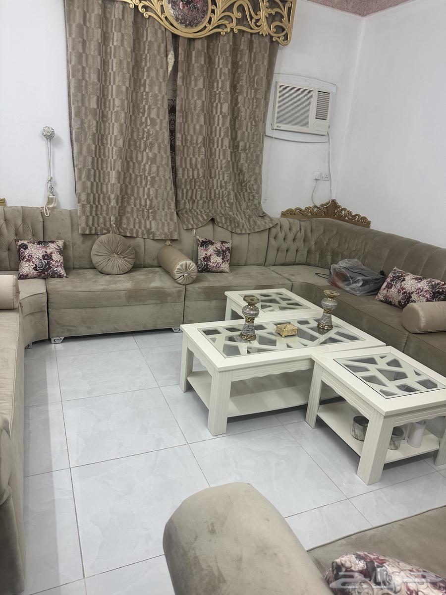 Beige sofa with curtain and tables63772425176835110