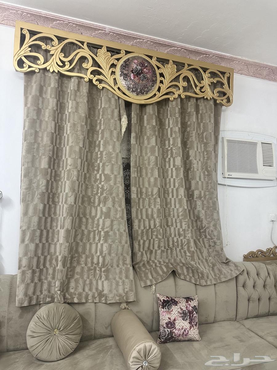 Beige sofa with curtain and tables63772425176835113