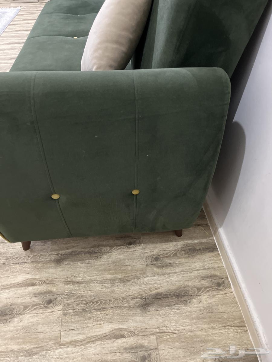 Good clean used olive sofa with storage that can be converted into a bed63798495219202111