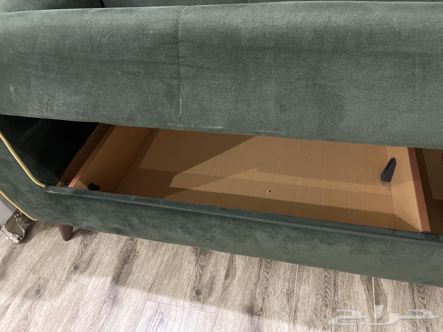 Good clean used olive sofa with storage that can be converted into a bed63798495219202112