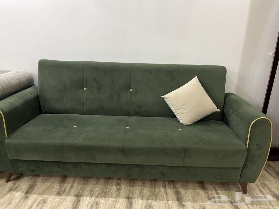 Good clean used olive sofa with storage that can be converted into a bed63798495219202110