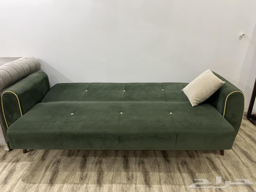 Good clean used olive sofa with storage that can be converted into a bed63798495219202113