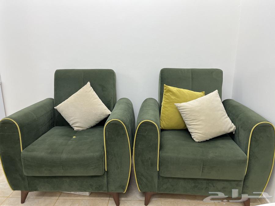 Good clean used olive sofa with storage that can be converted into a bed63798495219202114