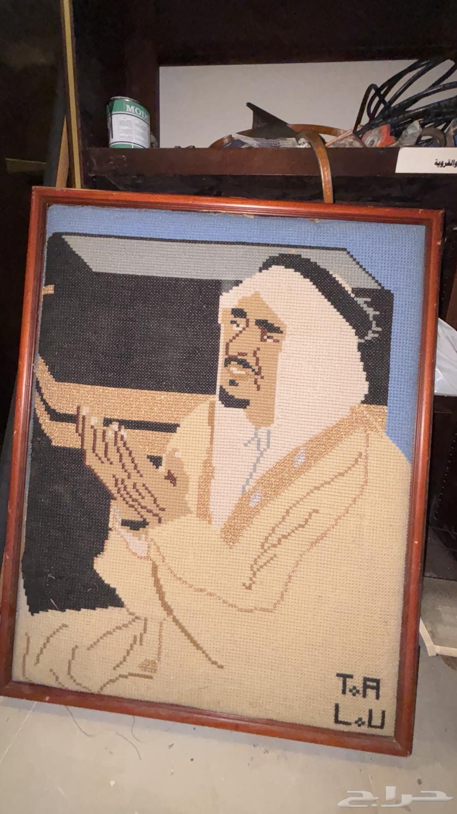 A tailor's board with a picture of King Fahd, may God have mercy on him64041347687554111