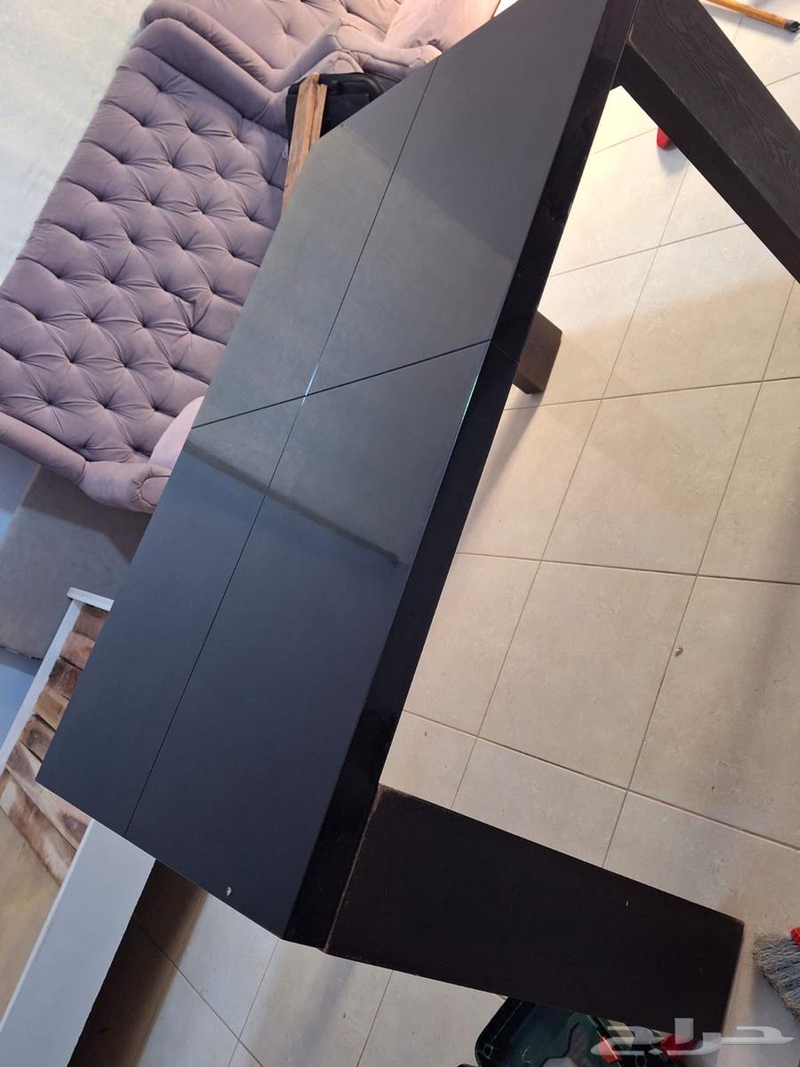 Modern wooden dining table with a glossy black surface64252648245507111