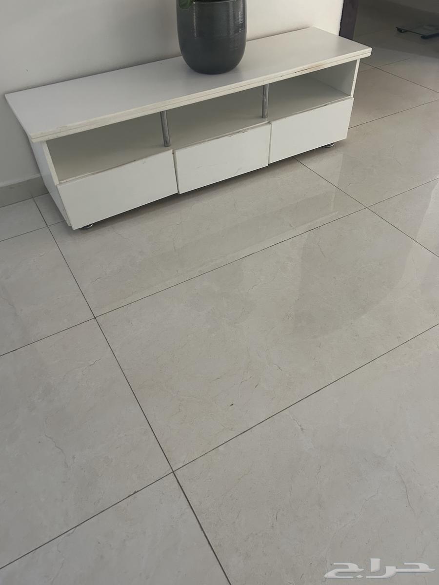 A small setup with a TV table that has slight scratches as shown in the photo64243691967618110