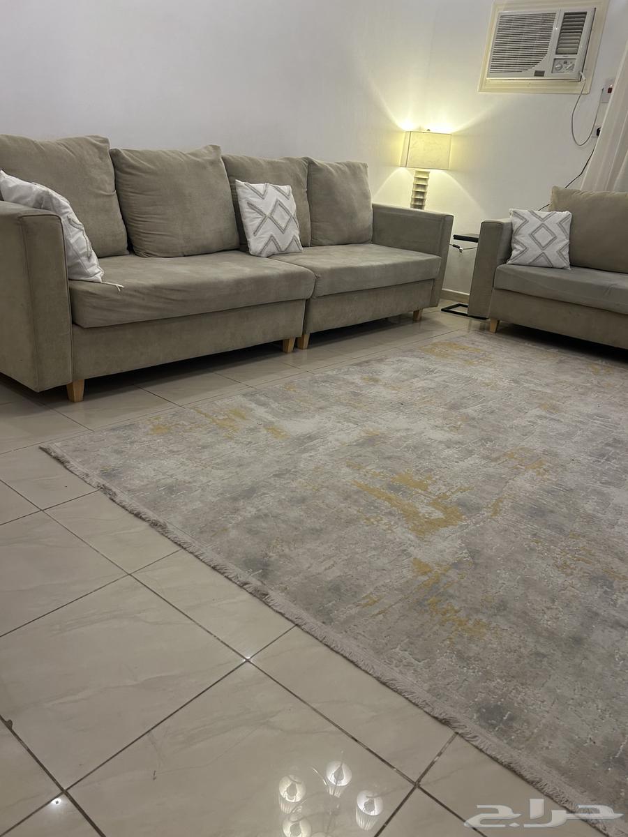 There is a sofa, carpet, and recliner64253438593794110