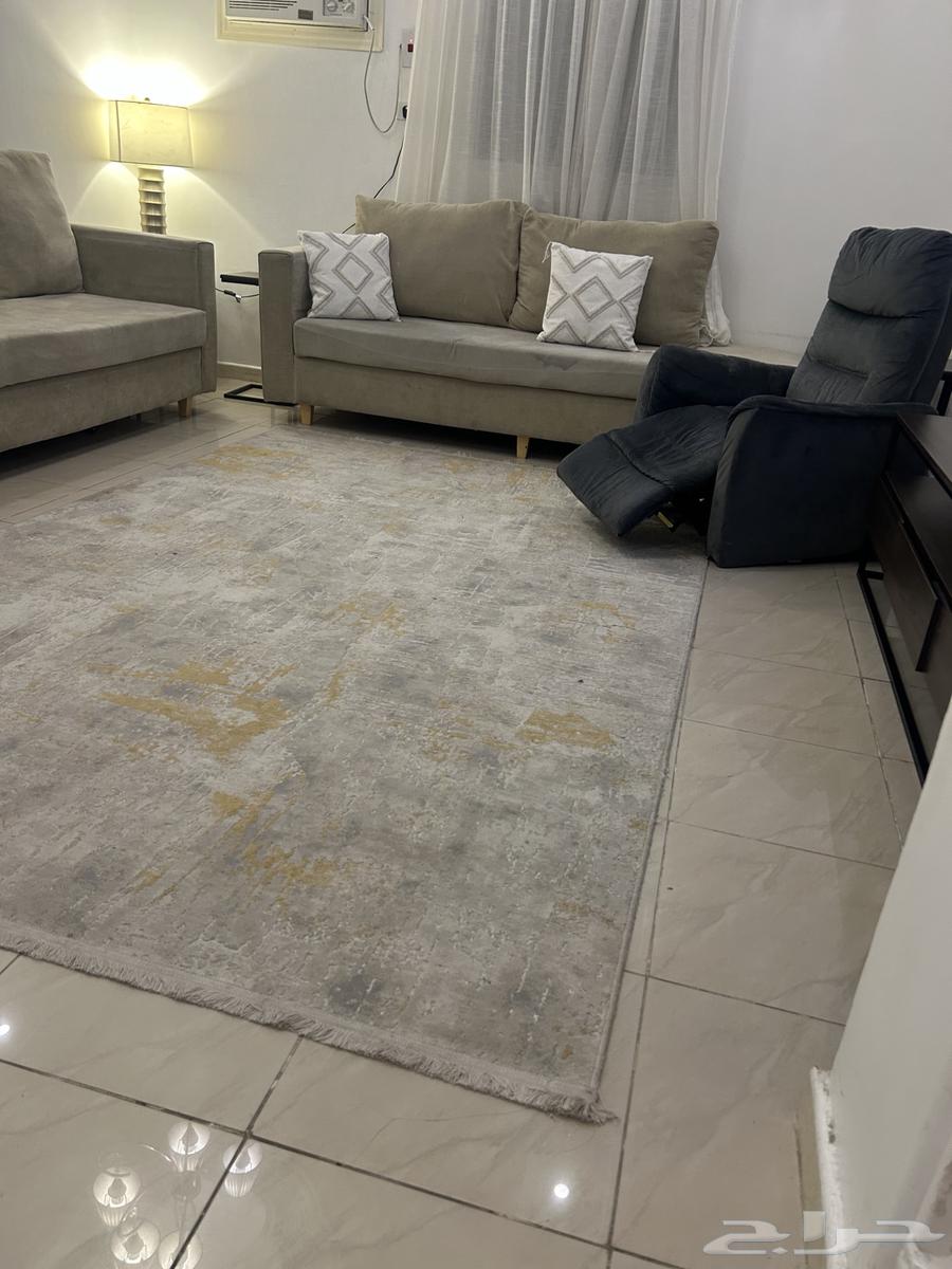 There is a sofa, carpet, and recliner64253438593794112