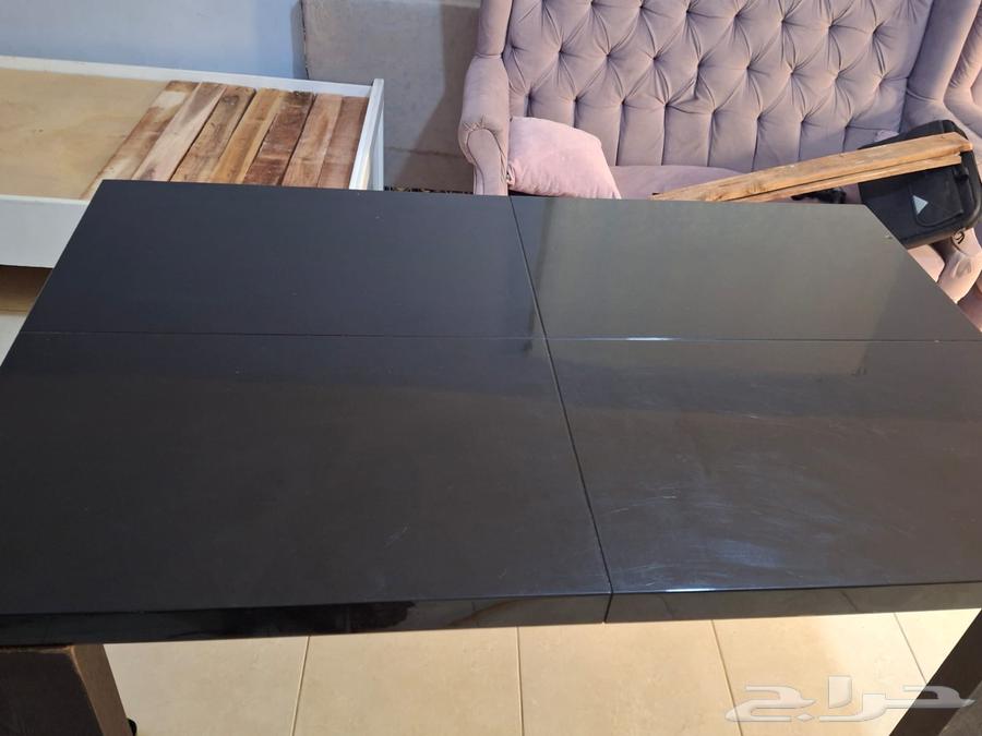 Modern wooden dining table with a glossy black surface64252648245507112