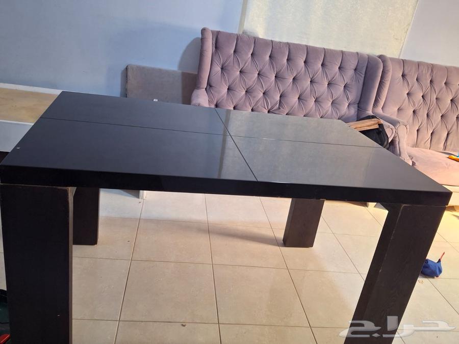 Modern wooden dining table with a glossy black surface64252648245507110