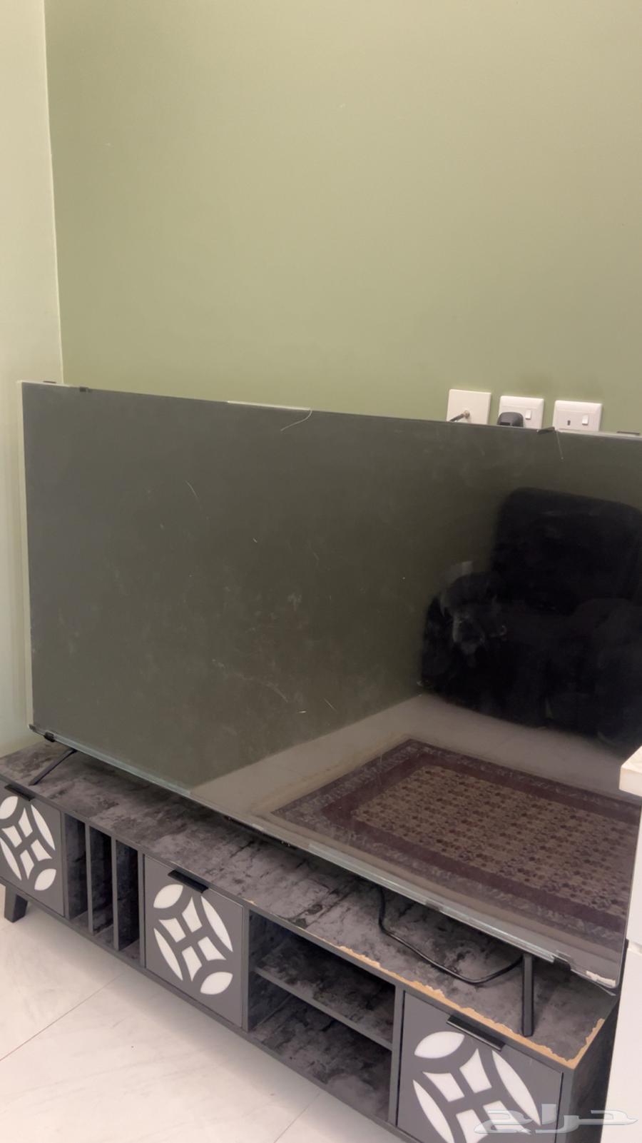 75-inch broken screen protector, table, and TV64353780268803113