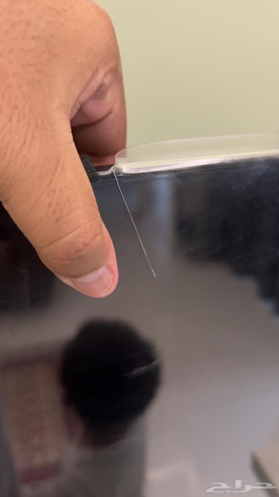 75-inch broken screen protector, table, and TV64353780268803112