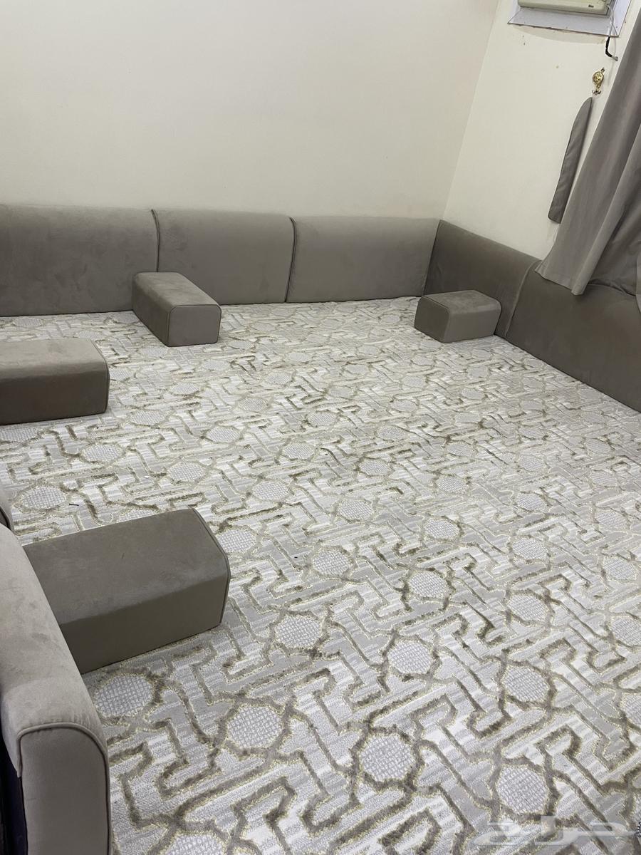 Sofa with angel, rug, table, and newly furnished room64386710830977111