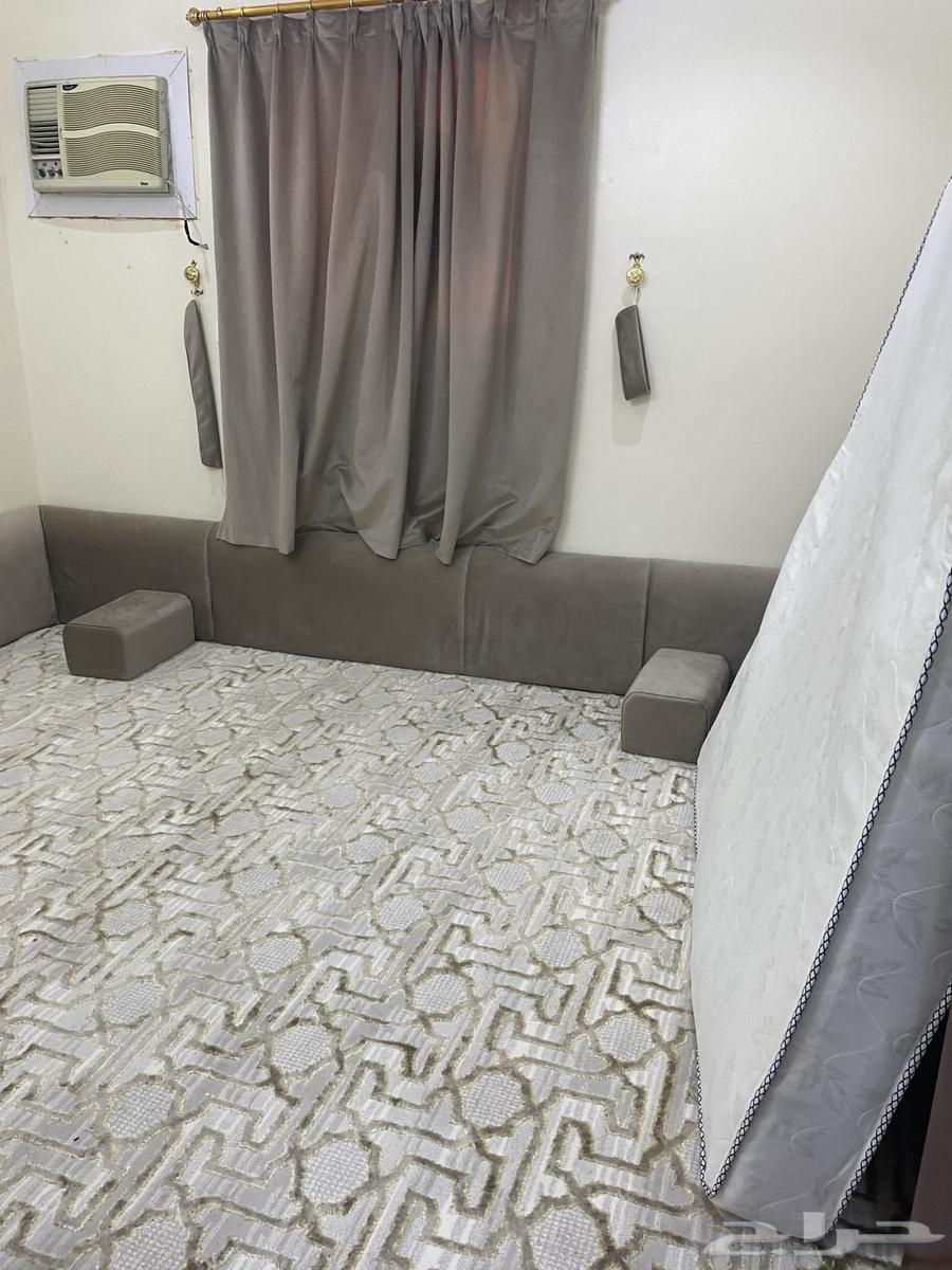 Sofa with angel, rug, table, and newly furnished room64386710830977110