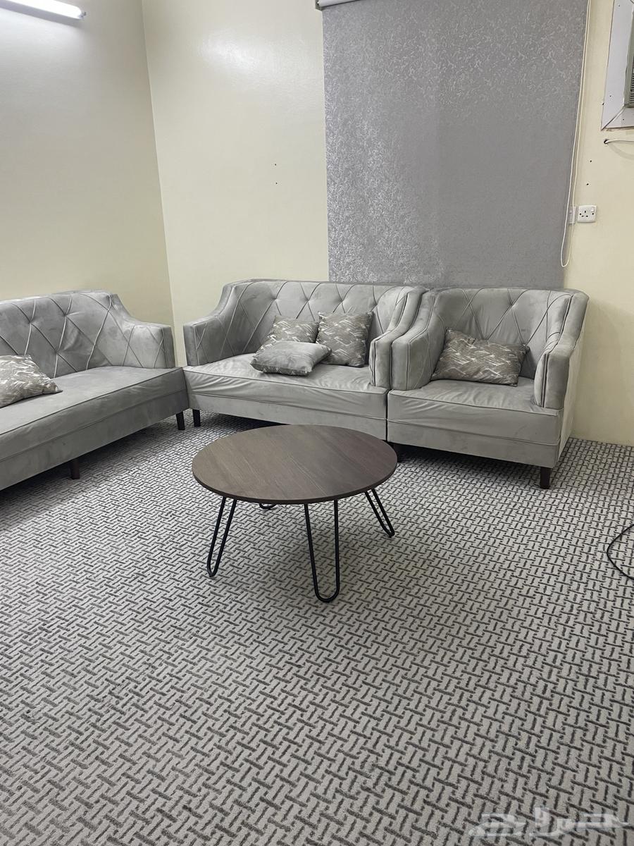 Sofa with angel, rug, table, and newly furnished room64386710830977113