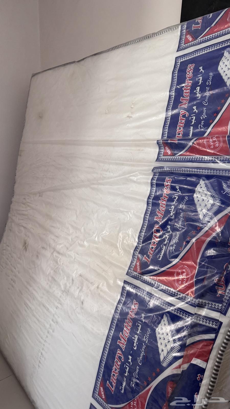 Bed with a new unused mattress64419238394113112