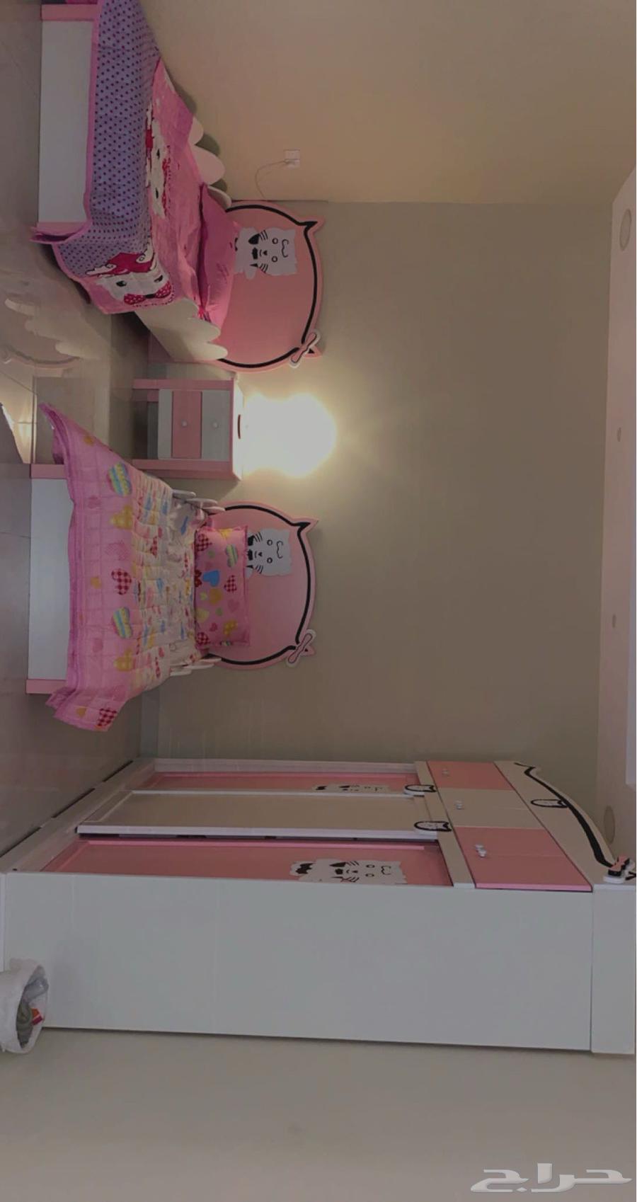 A bedroom with two beds, a dresser, and a large wardrobe, no defects or damage64429438250499110