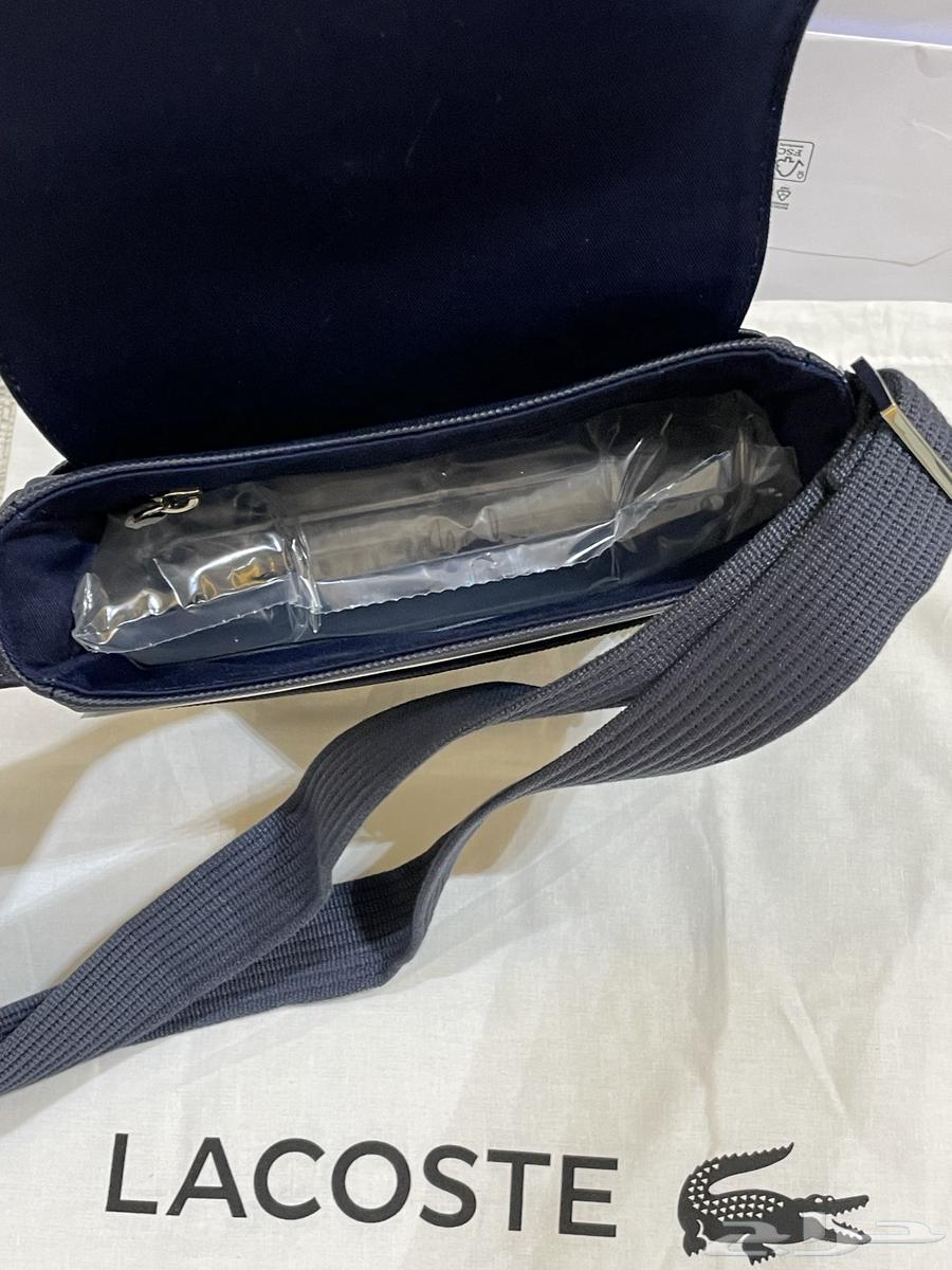 شنطة لاكوست اصلية جديدة مع كيس الوكيل64467536069122114