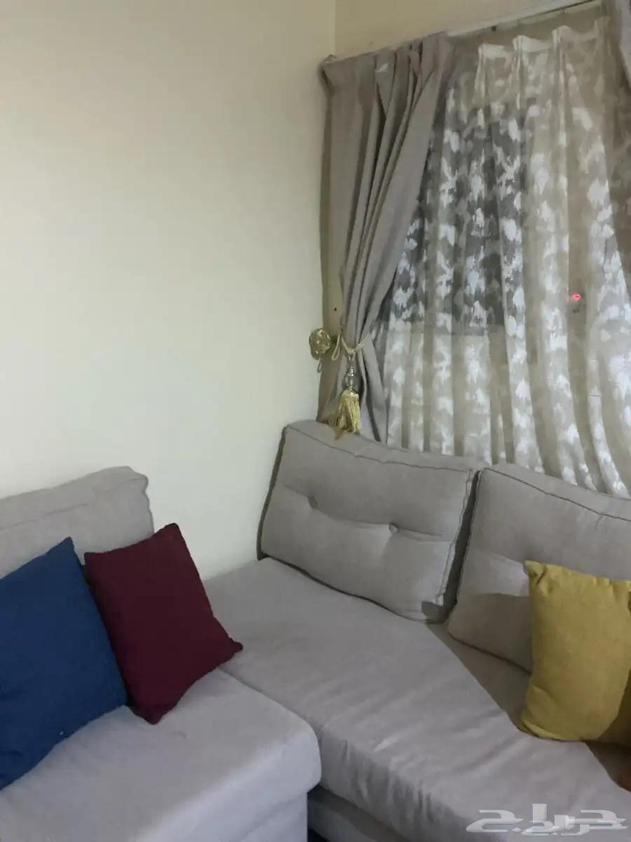 L-shaped corner sofa with table and curtain. Price is one thousand, negotiable.64485611564035112