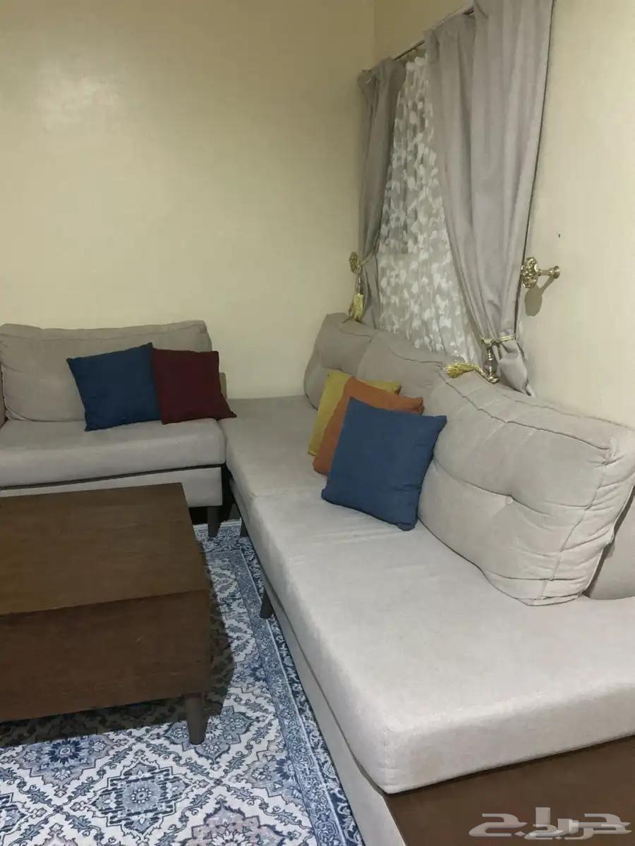L-shaped corner sofa with table and curtain. Price is one thousand, negotiable.64485611564035111