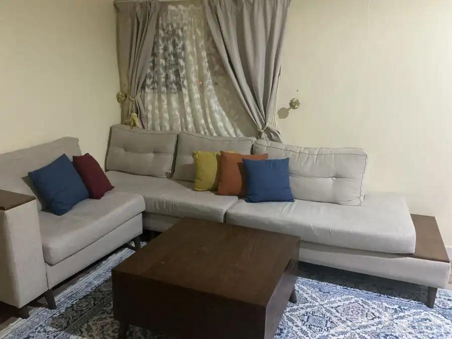 L-shaped corner sofa with table and curtain. Price is one thousand, negotiable.64485611564035110