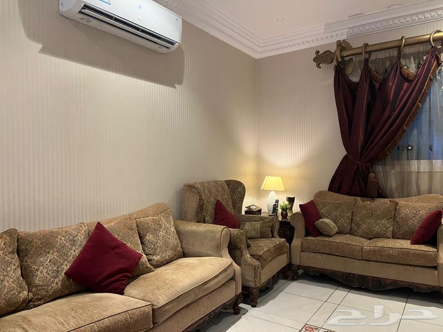 American sofa for sale with curtains, two tables, and an art painting64502336876547111