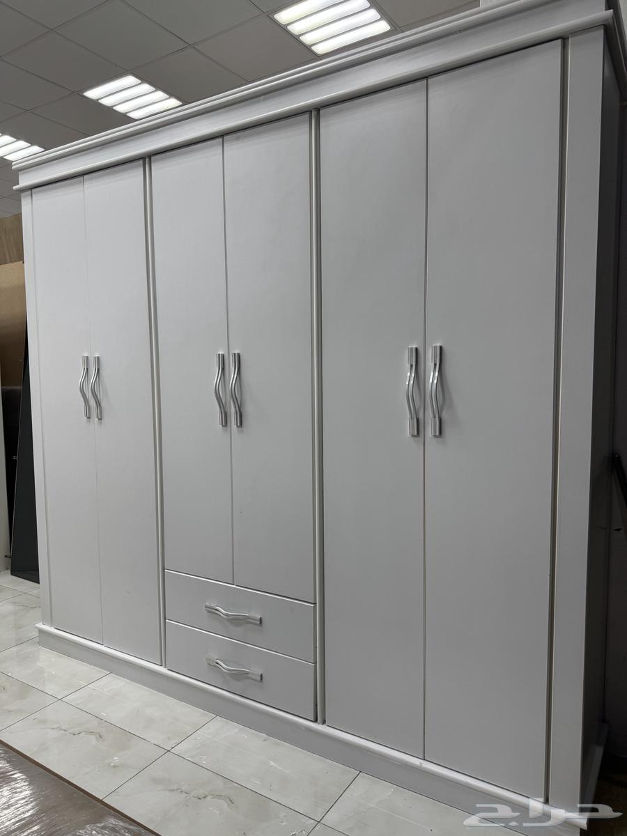 Clothes closets in a bedroom with a single bed, used and clean64527348141057112