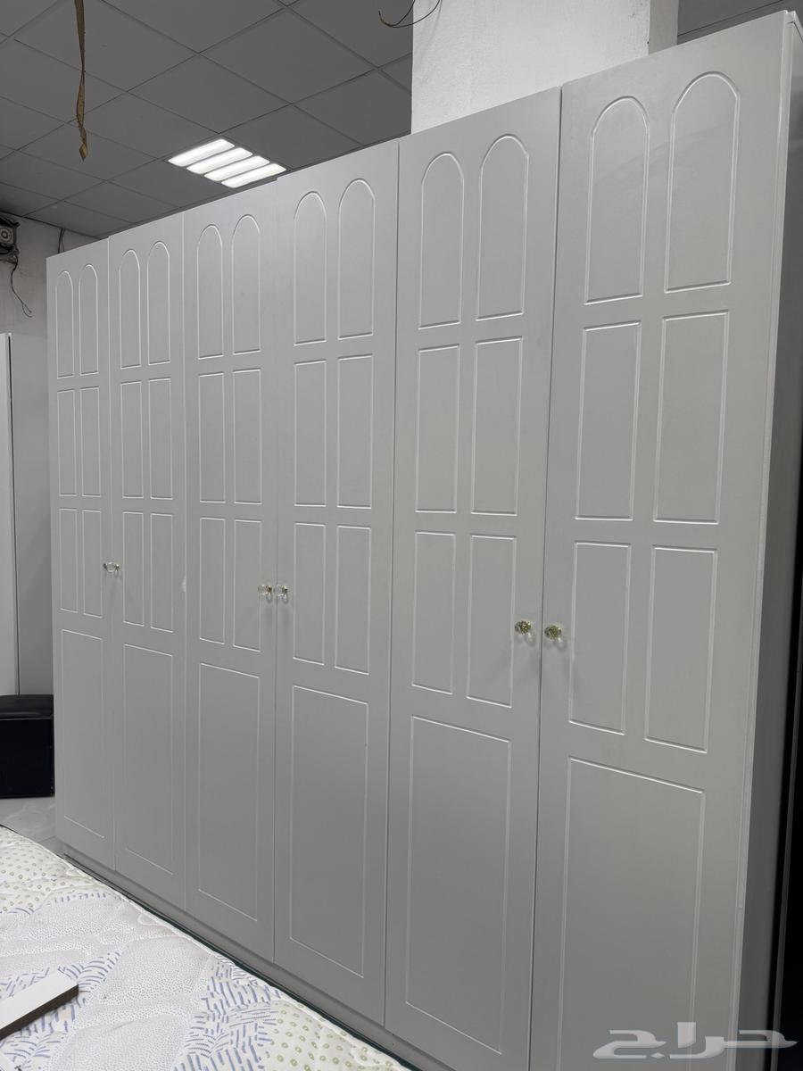 Clothes closets in a bedroom with a single bed, used and clean64527348141057111