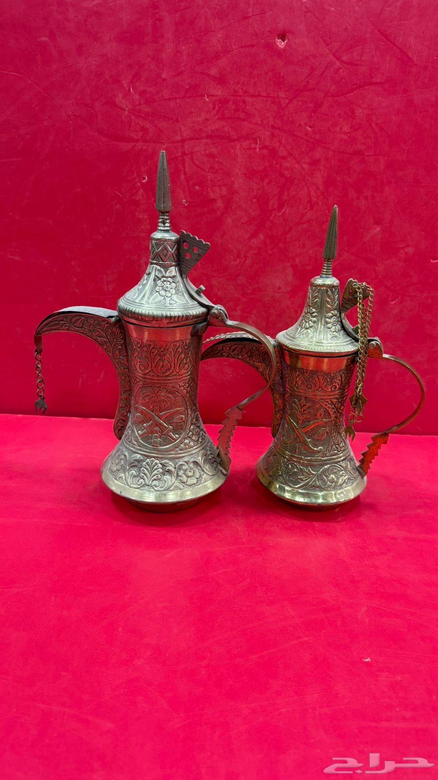 Two vintage sets of Quraysh-style coffee pots with two swords, a palm tree, and traditional decorations64538795114113111