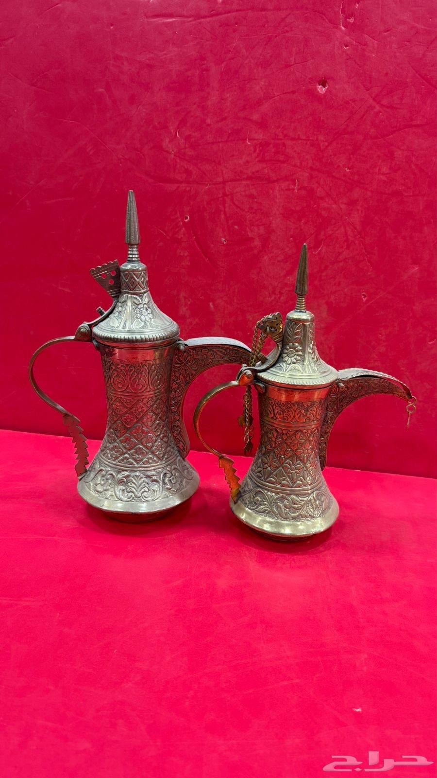 Two vintage sets of Quraysh-style coffee pots with two swords, a palm tree, and traditional decorations64538795114113112
