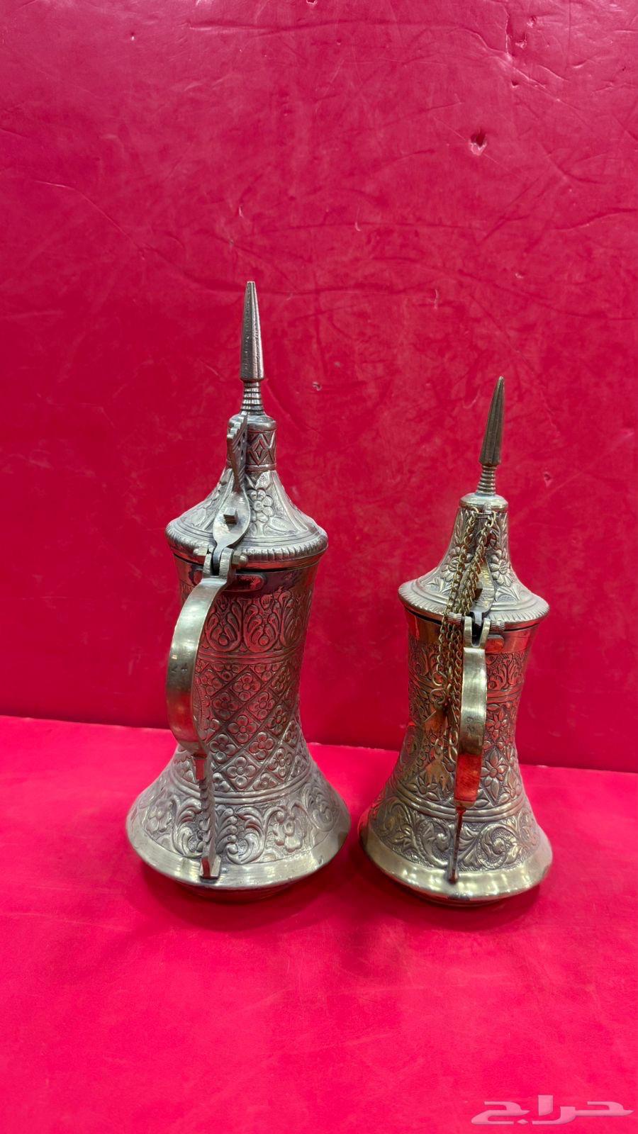 Two vintage sets of Quraysh-style coffee pots with two swords, a palm tree, and traditional decorations64538795114113110