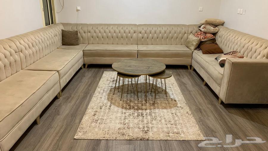 Sofa for sale with tables and rugs; stains present on the sofa64609299328643110