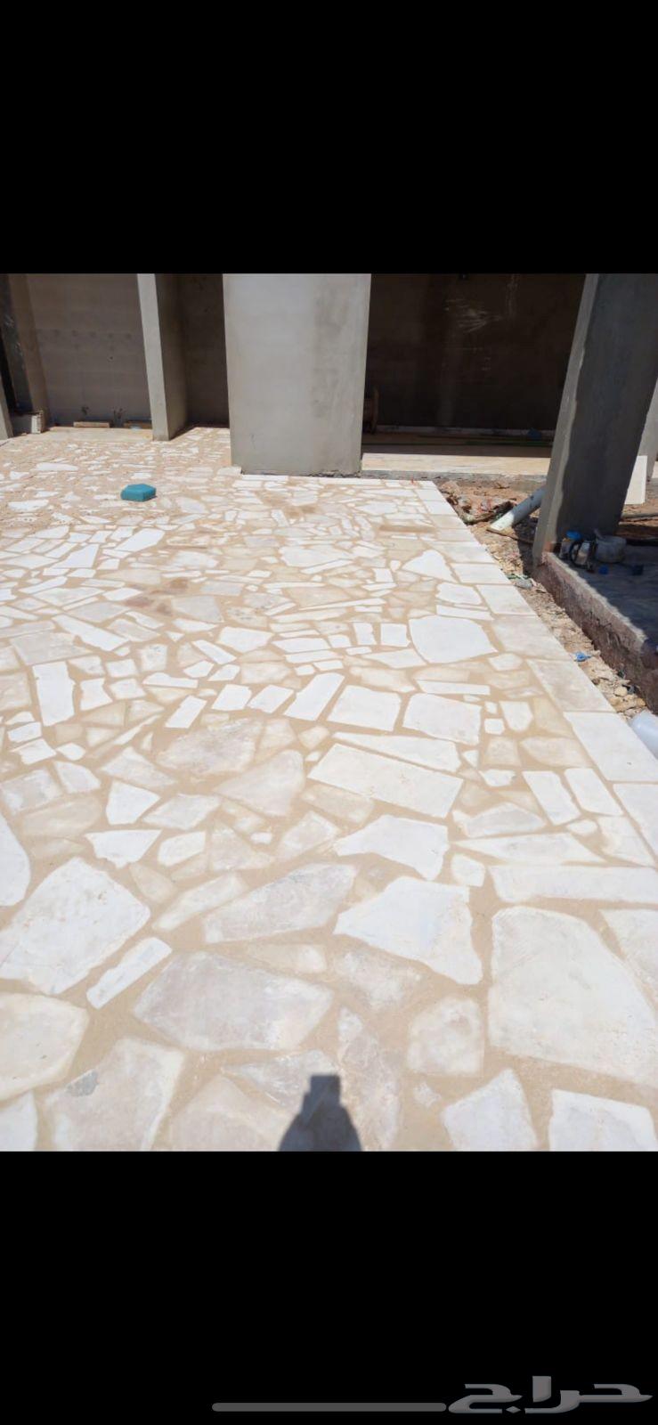 Installation of random white and yellow stone, paving, marble, and stone seating64214576230531110